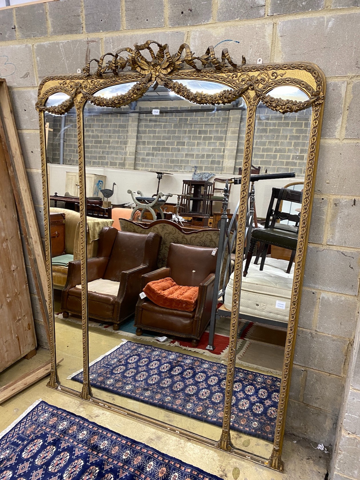 A Victorian giltwood and composition overmantel wall mirror with swagged ribbonfold surmount, width 148cm, height 199cm